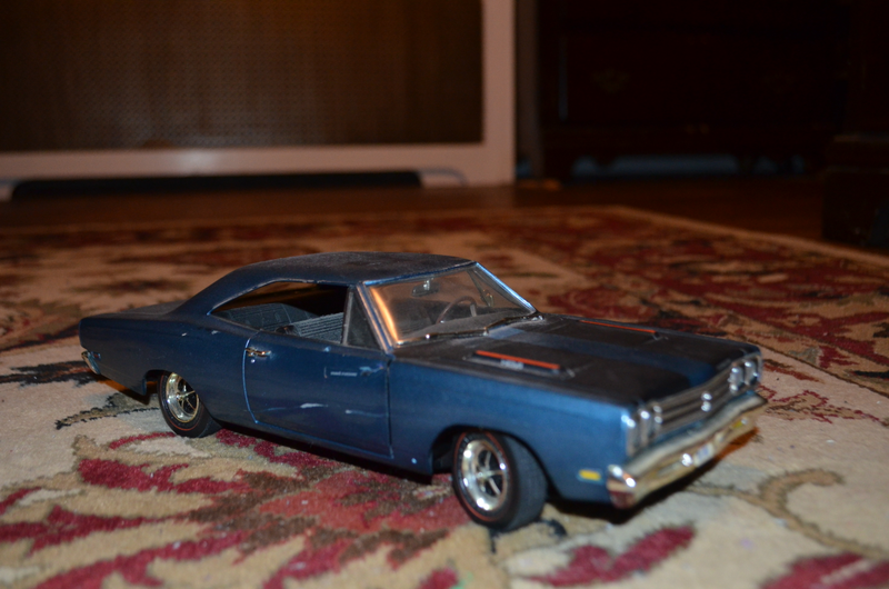 1/18 Plymouth Road Runner. Scuffs on passenger door, small touched up paint spot in black stripe on front of hood.